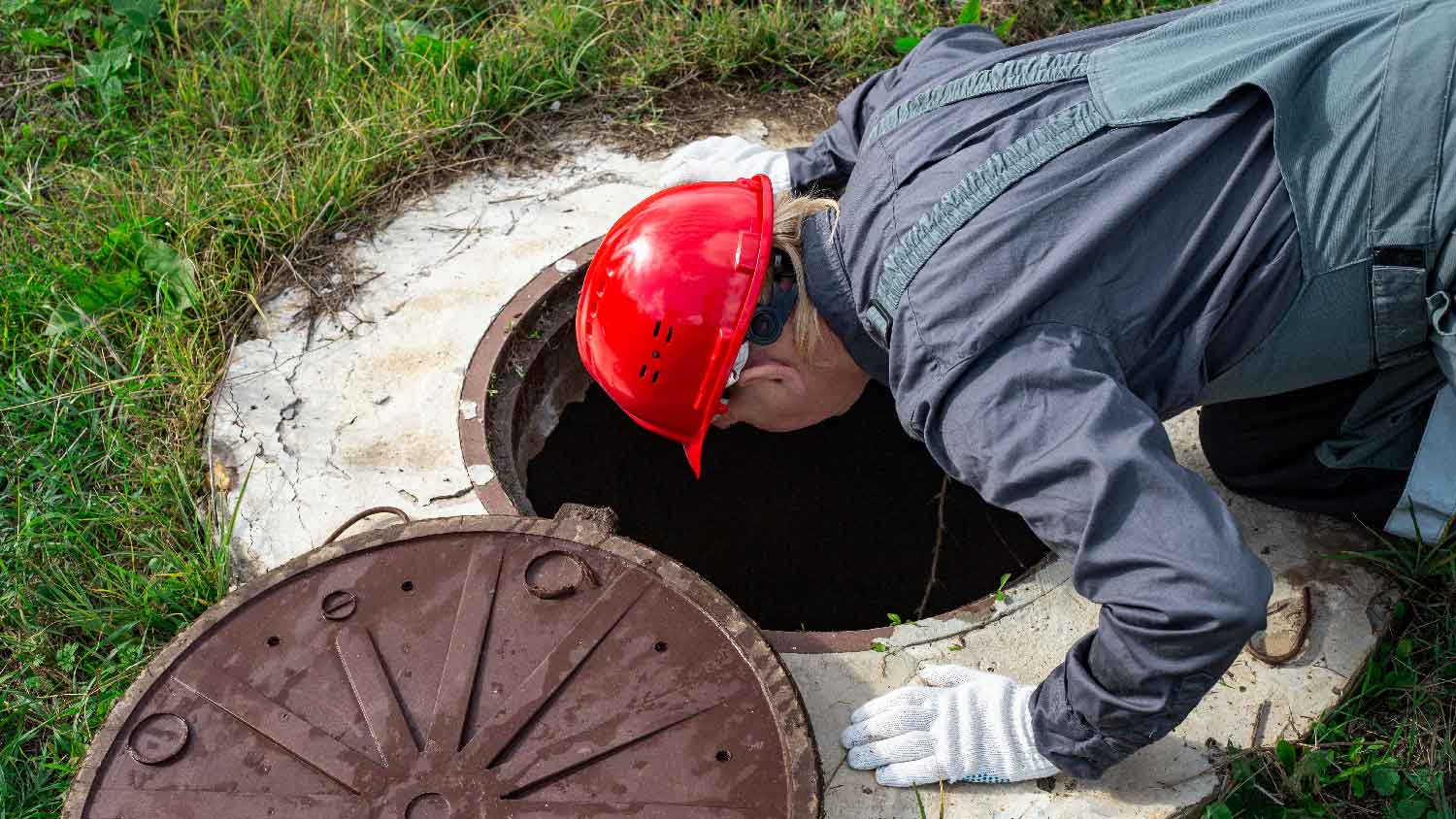 A professional inspecting a water well