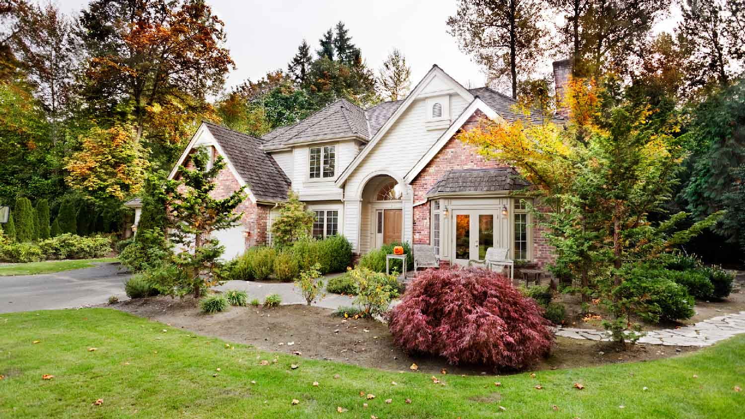 A beautiful house with bushes in its front yard