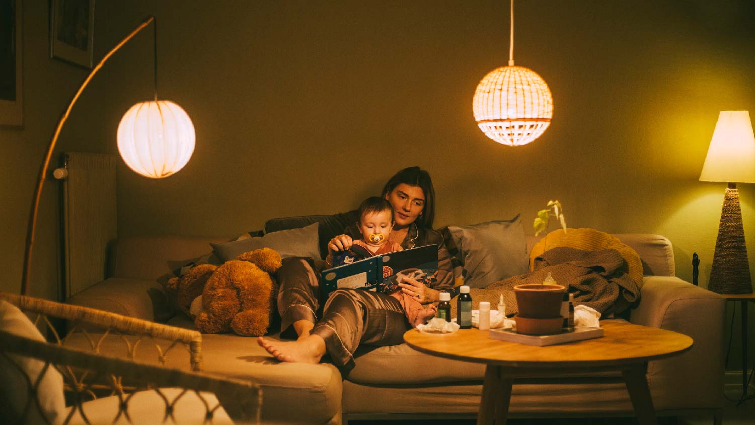A mother reading a fairytale to her baby at night