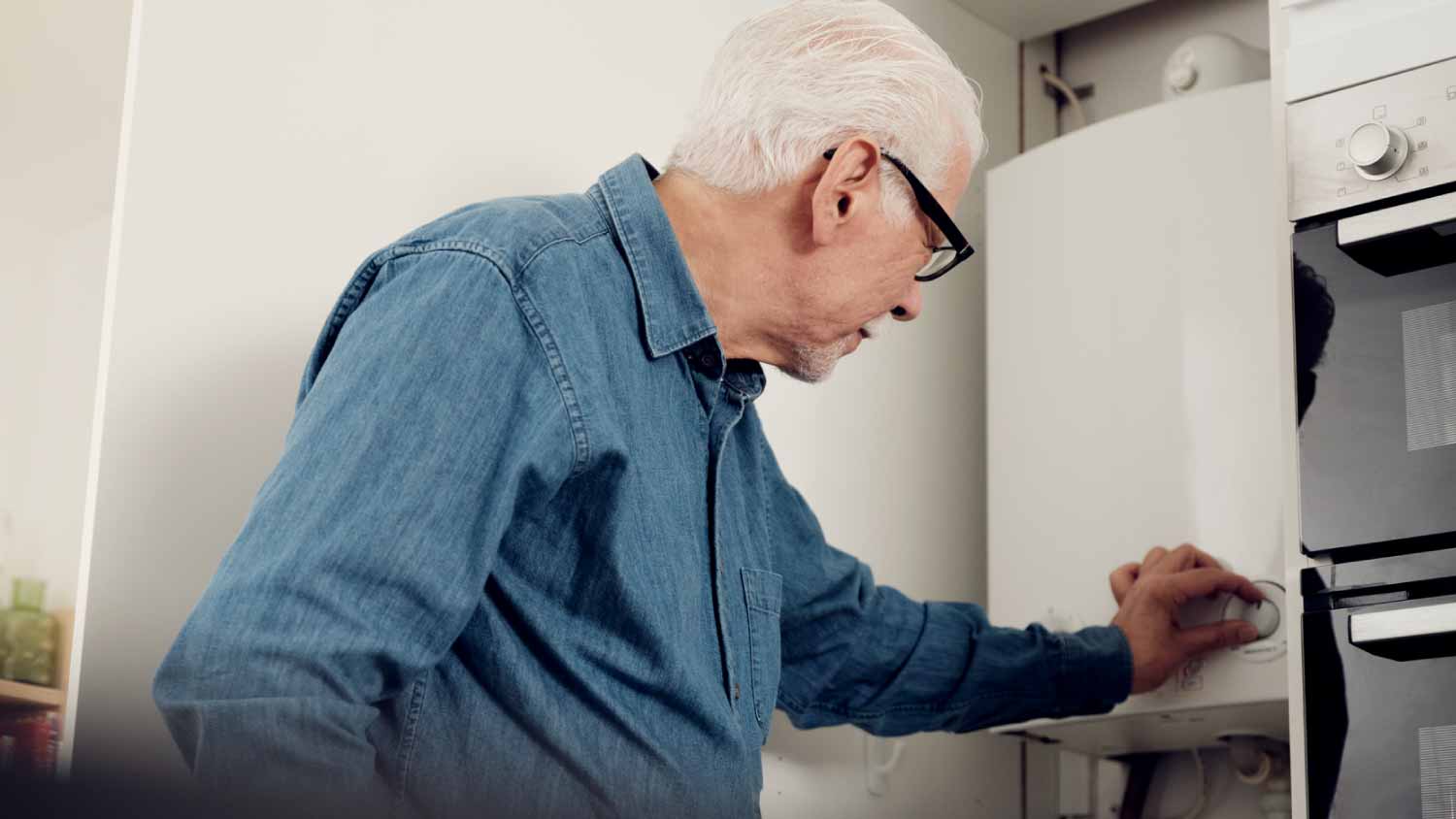 Man adjusting boiler