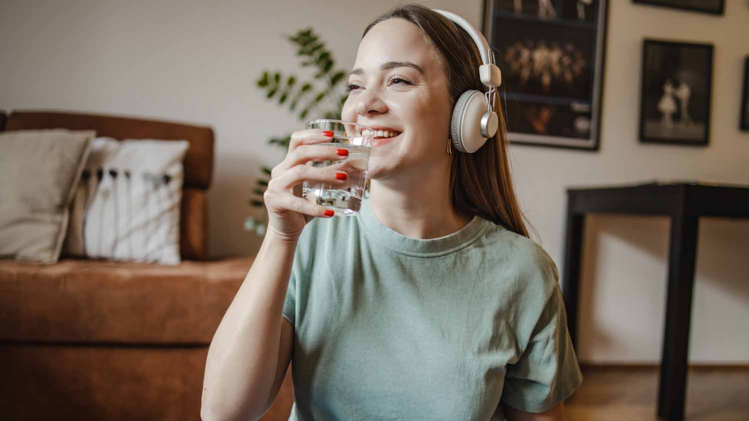Woman drinking water at home