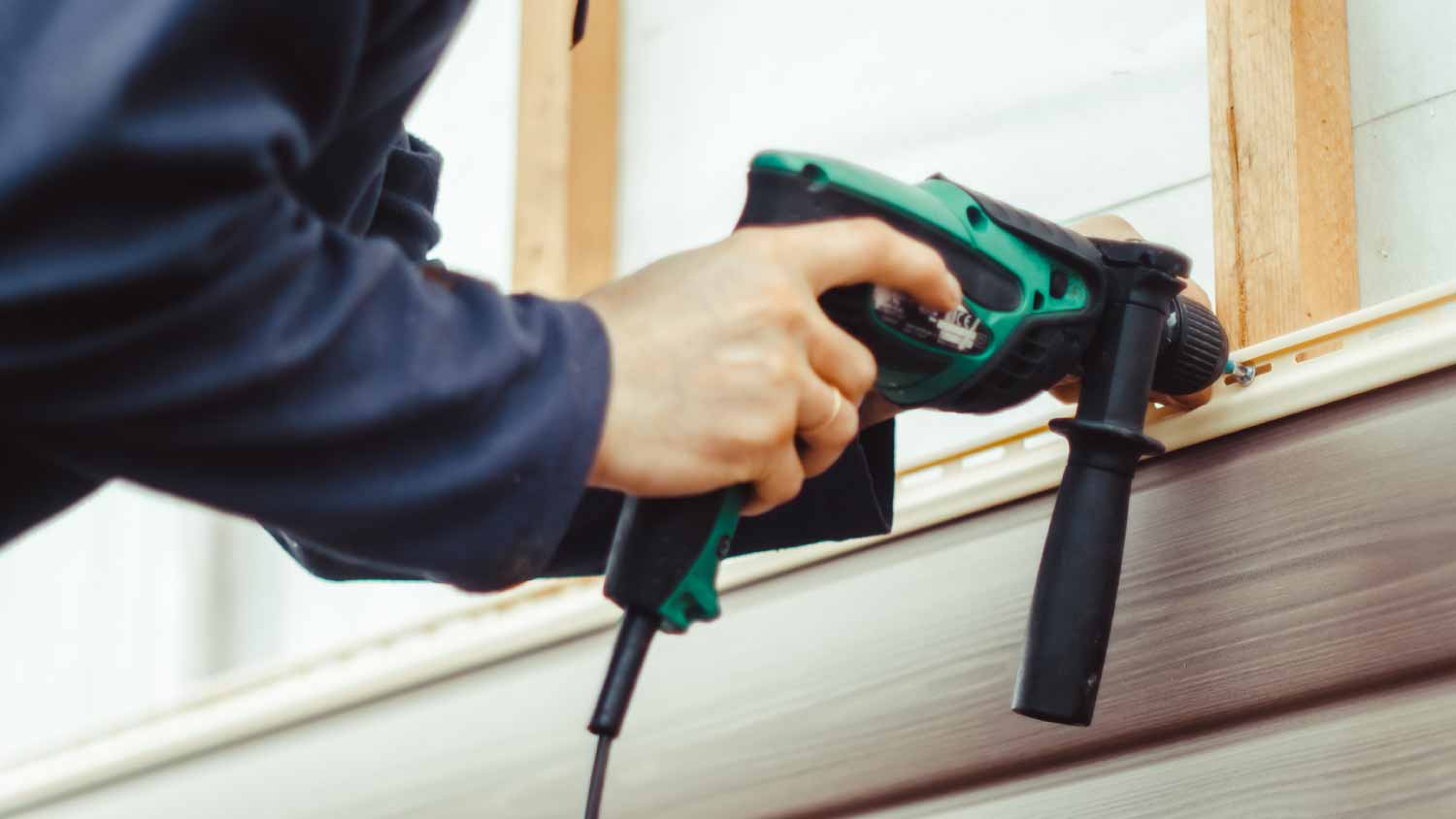 Worker installing siding