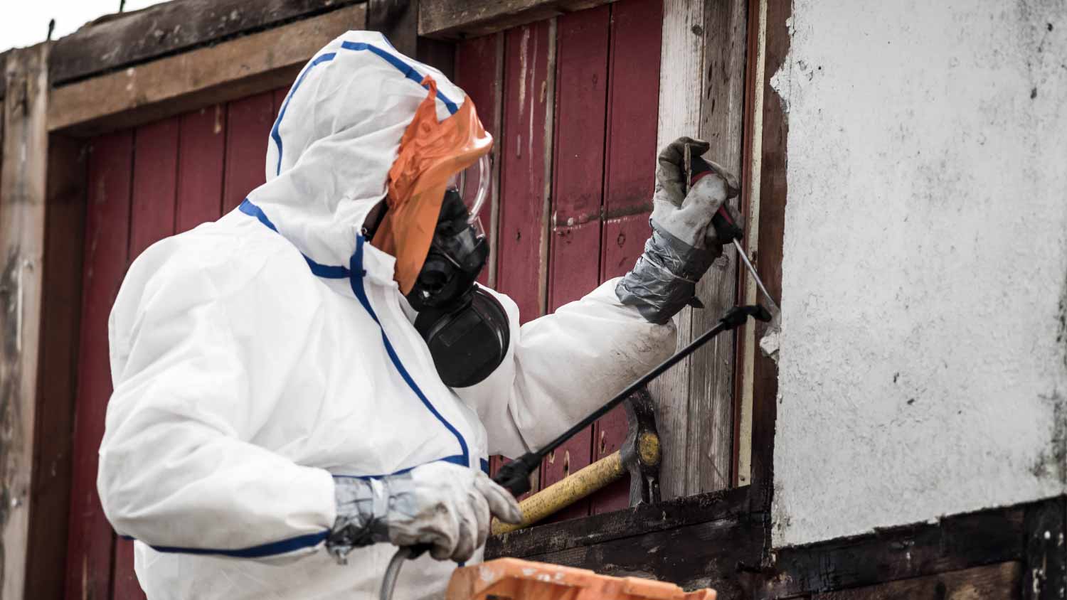 Man removing asbestos on a construction site
