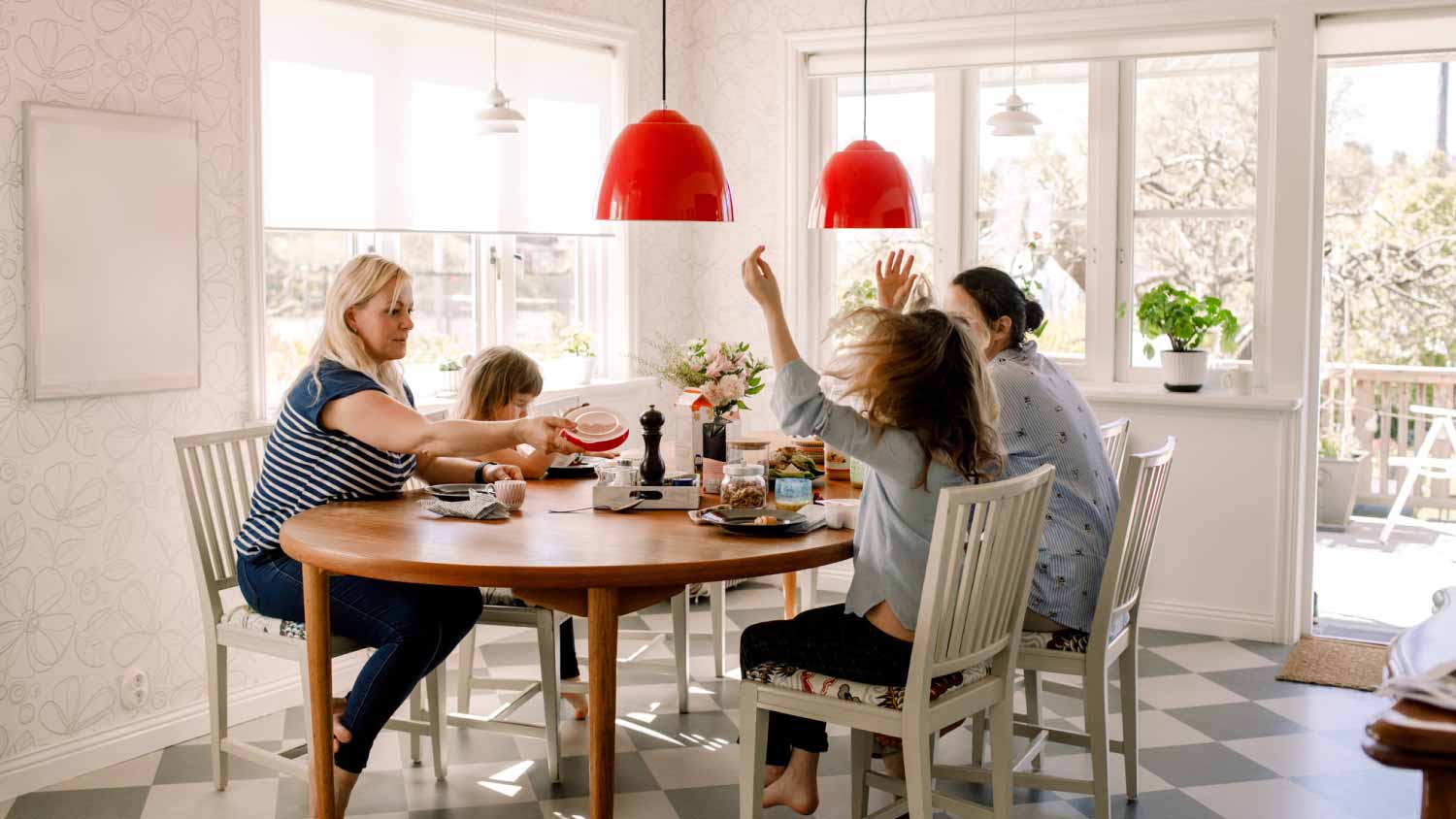 Mothers having breakfast with daughters