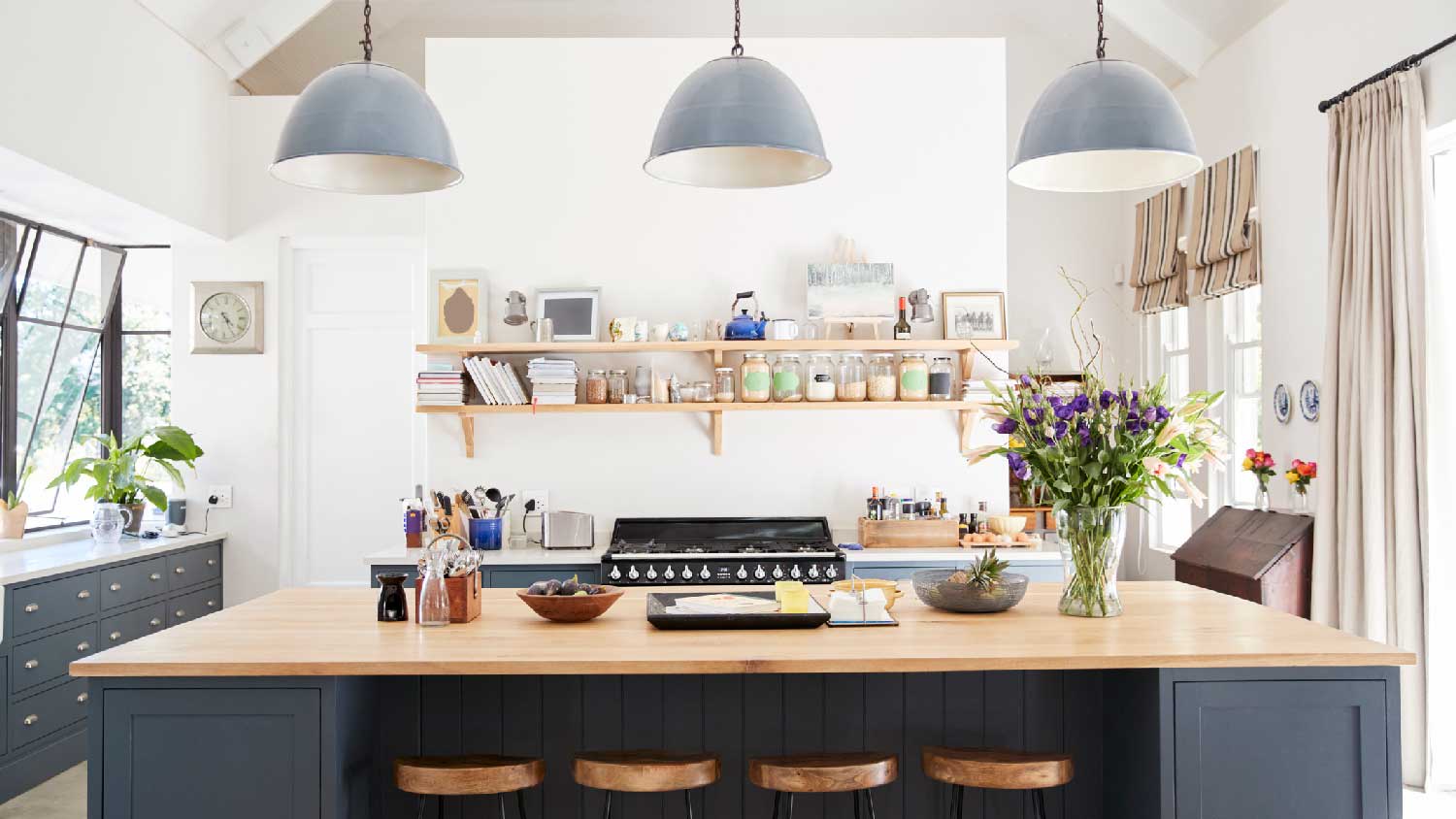 A kitchen island with three pendant lights