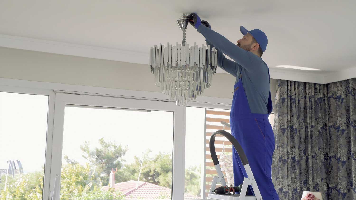 A professional fixing a chandelier’s wiring
