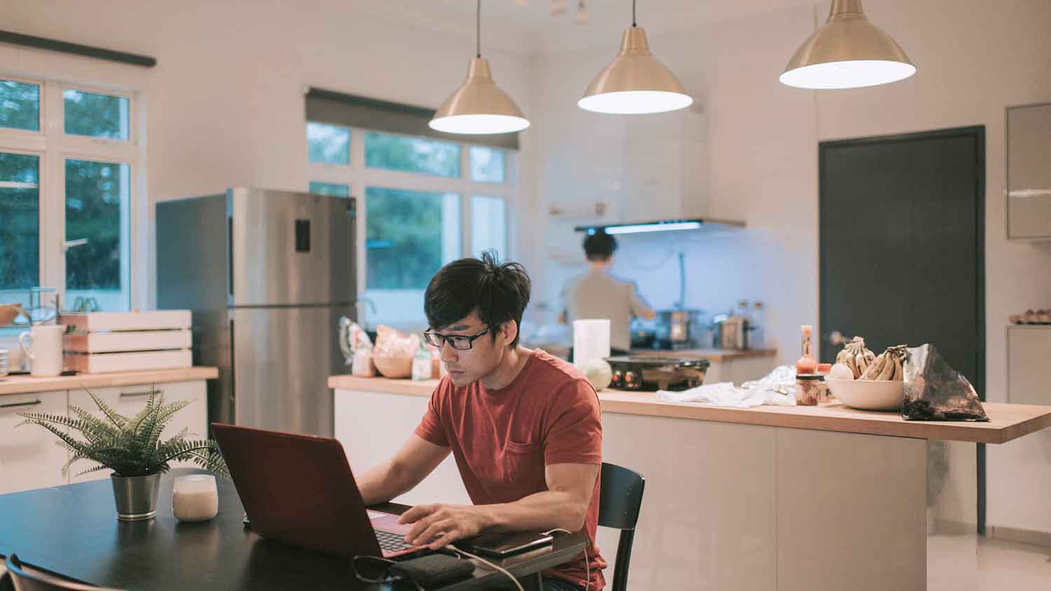 Man using laptop in the dining room