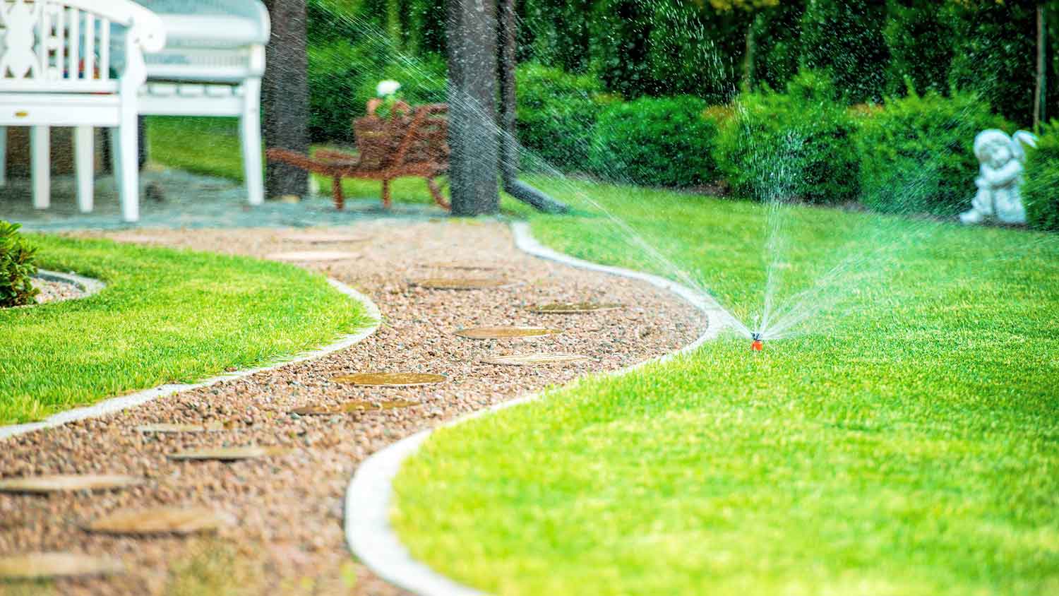 Automatic sprinkler watering the yard
