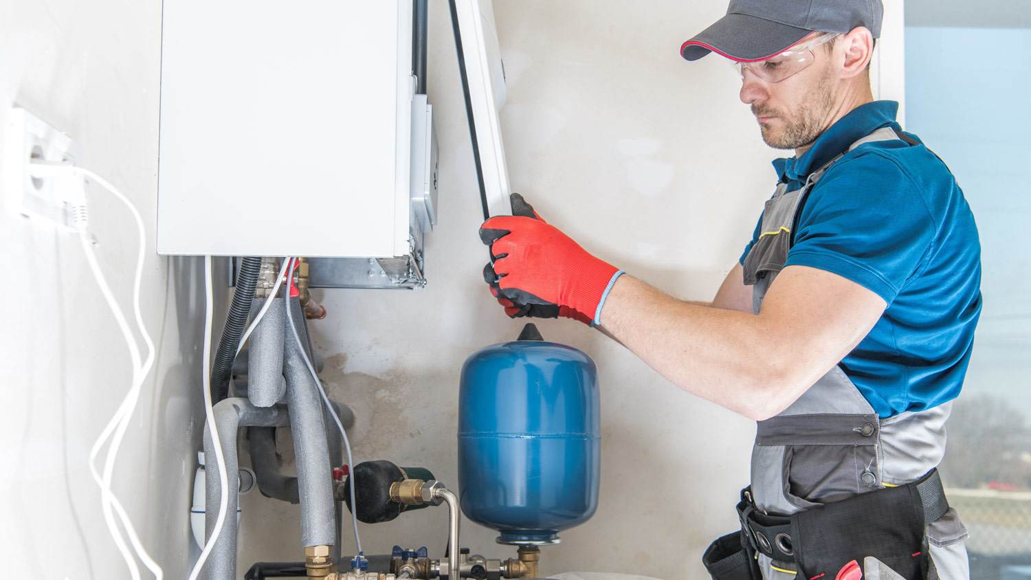 A professional repairing a house furnace