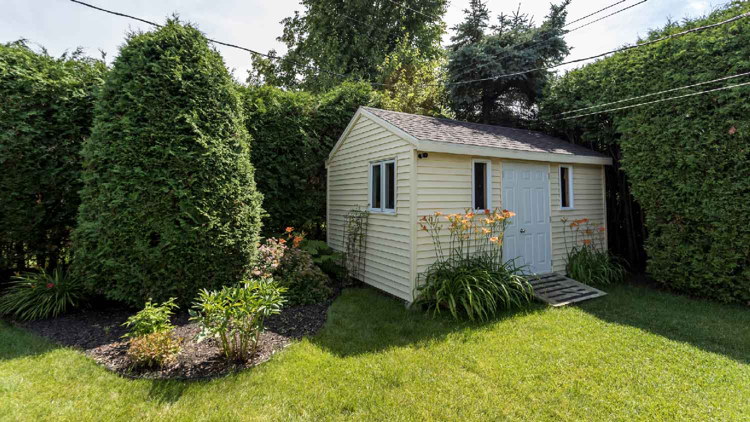 A beautiful shed in the backyard of a house
