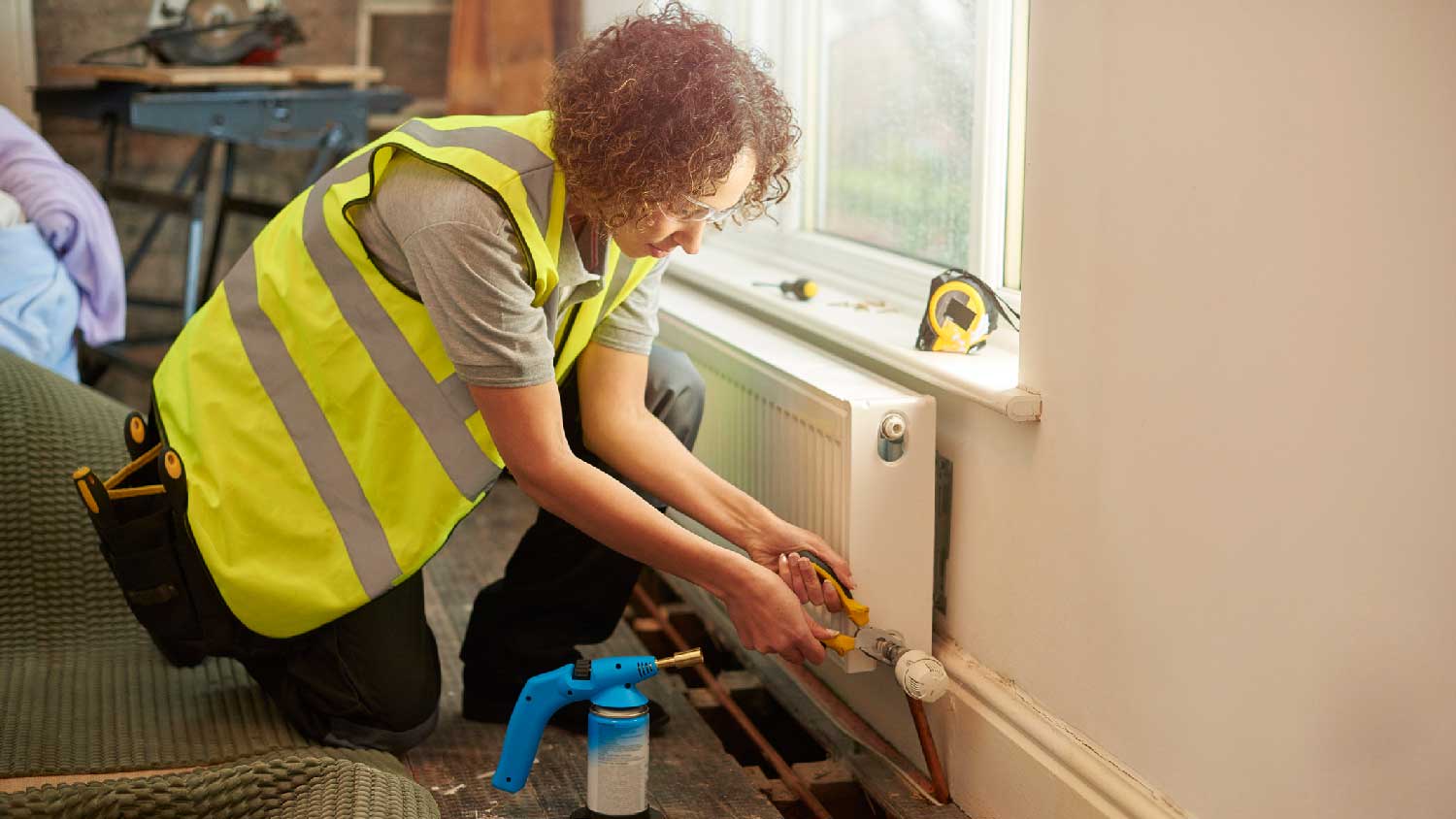 A plumber fixing a water leak