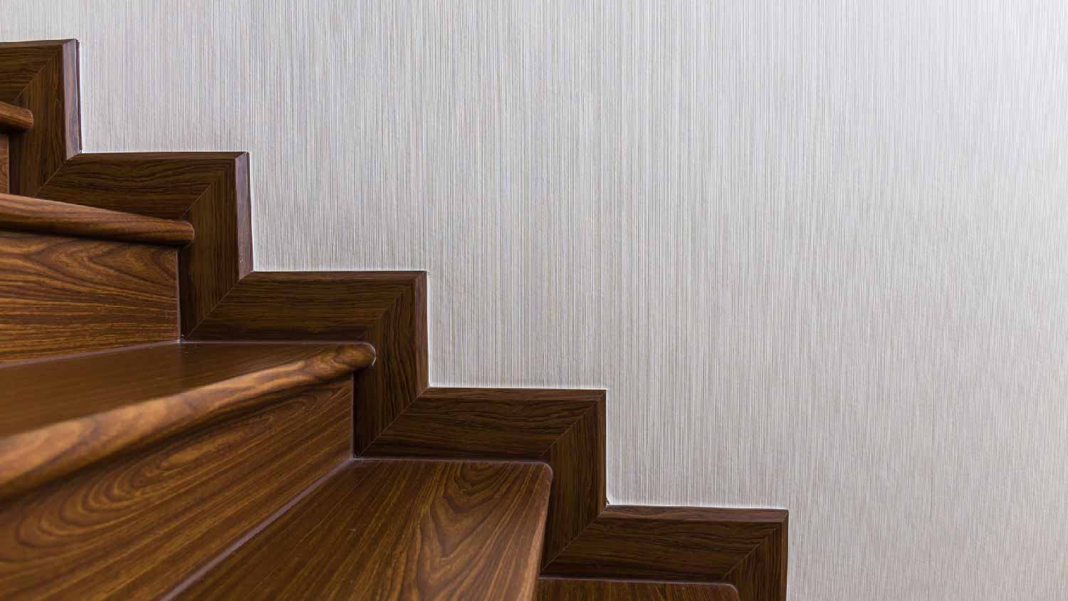 A wooden staircase with matching baseboard