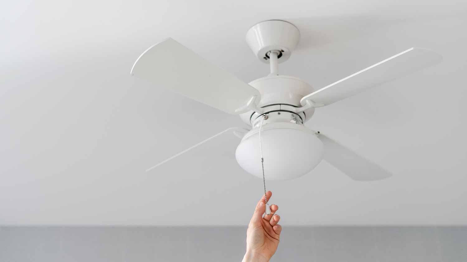 Woman turning on electric ceiling