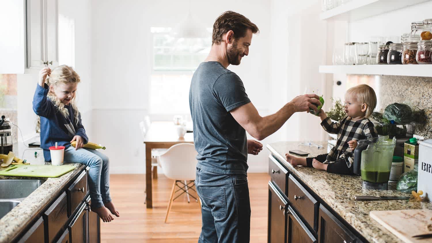 Father feeding kid on granite counters