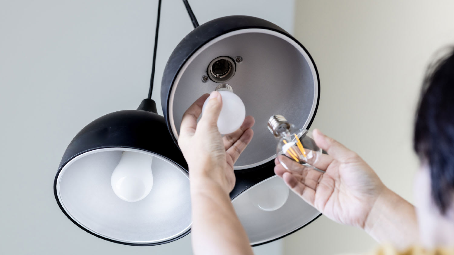A man changing a light bulb