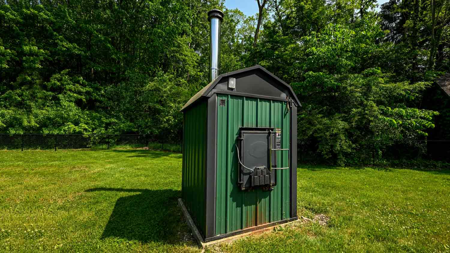 outdoor wood furnace in yard