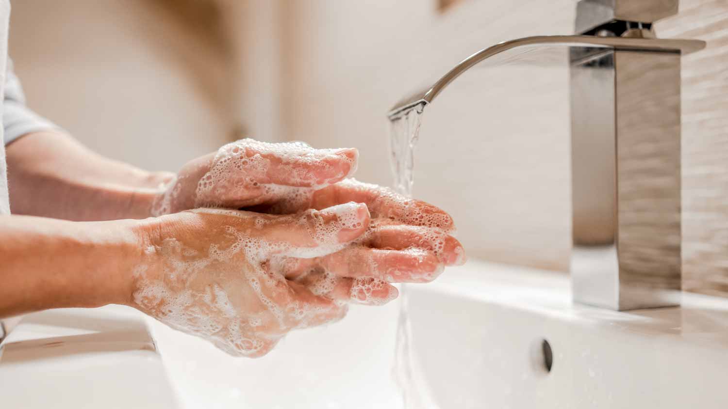 Woman washing hands with soap