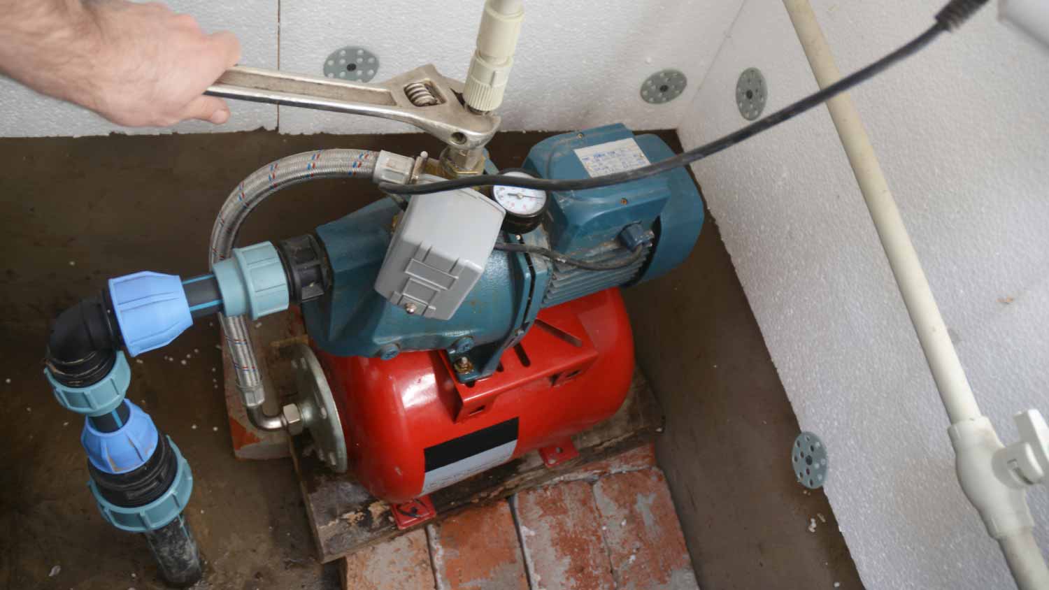 Worker repairing water pumping station
