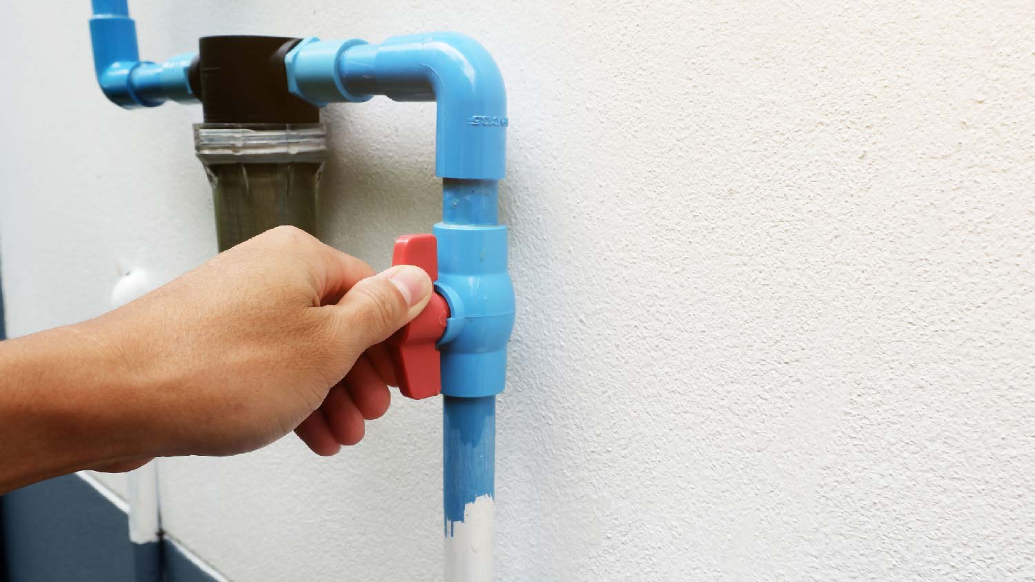 A person switching on an irrigation valve