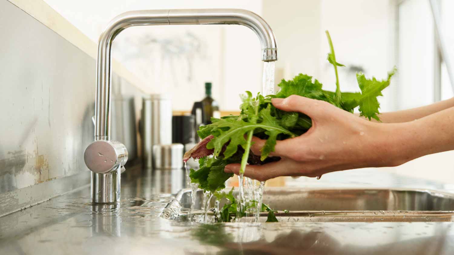woman washing vegetables