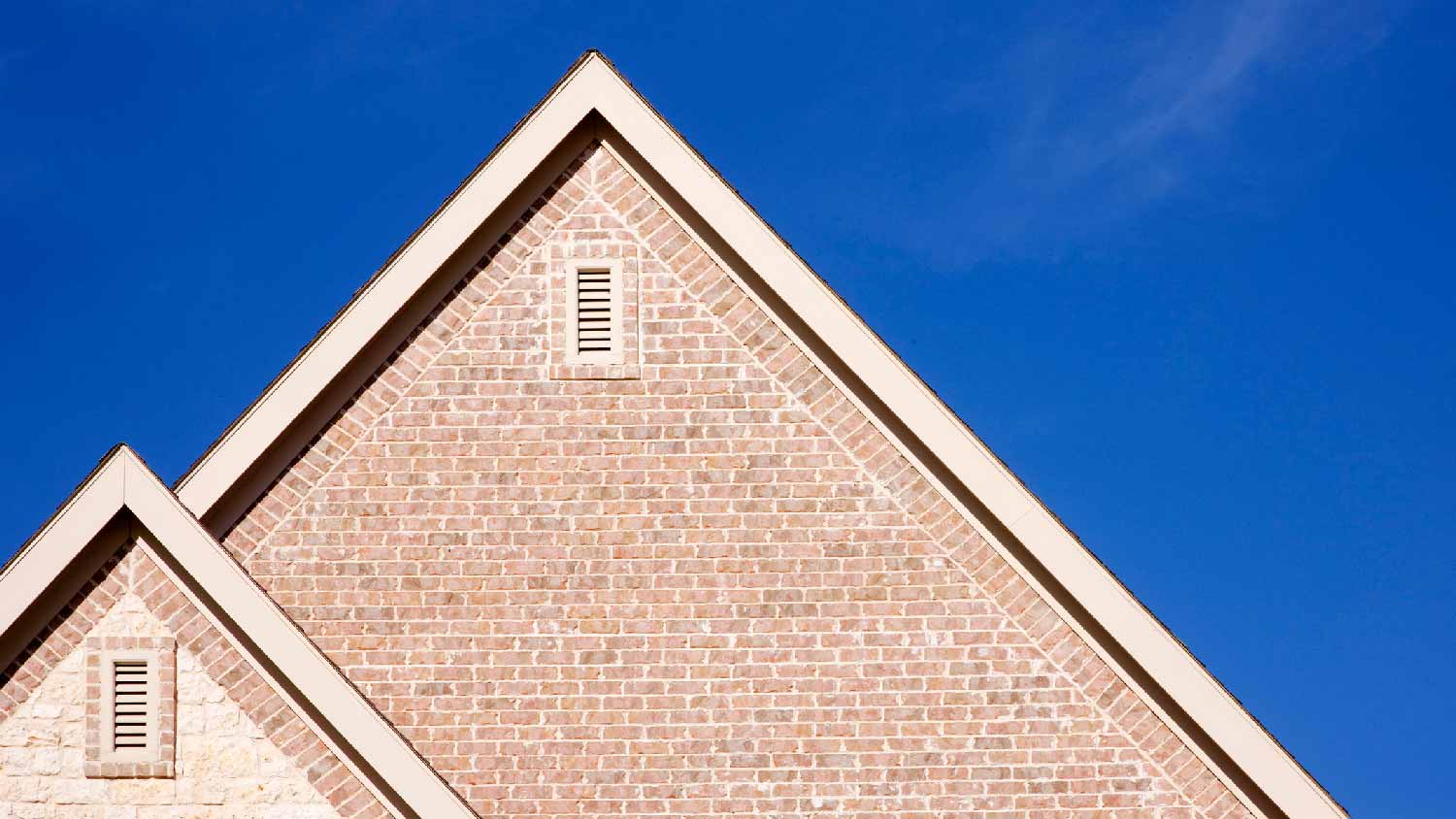 A red brick house with a gable vent