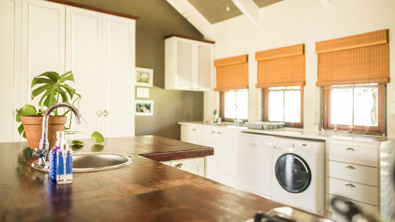 A wooden countertop in a kitchen with vaulted kitchen