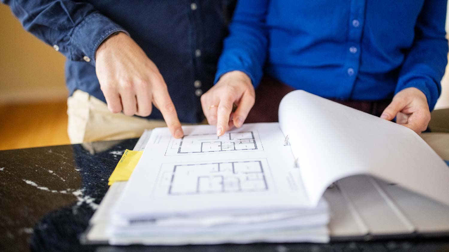 A couple looking at a floor plan