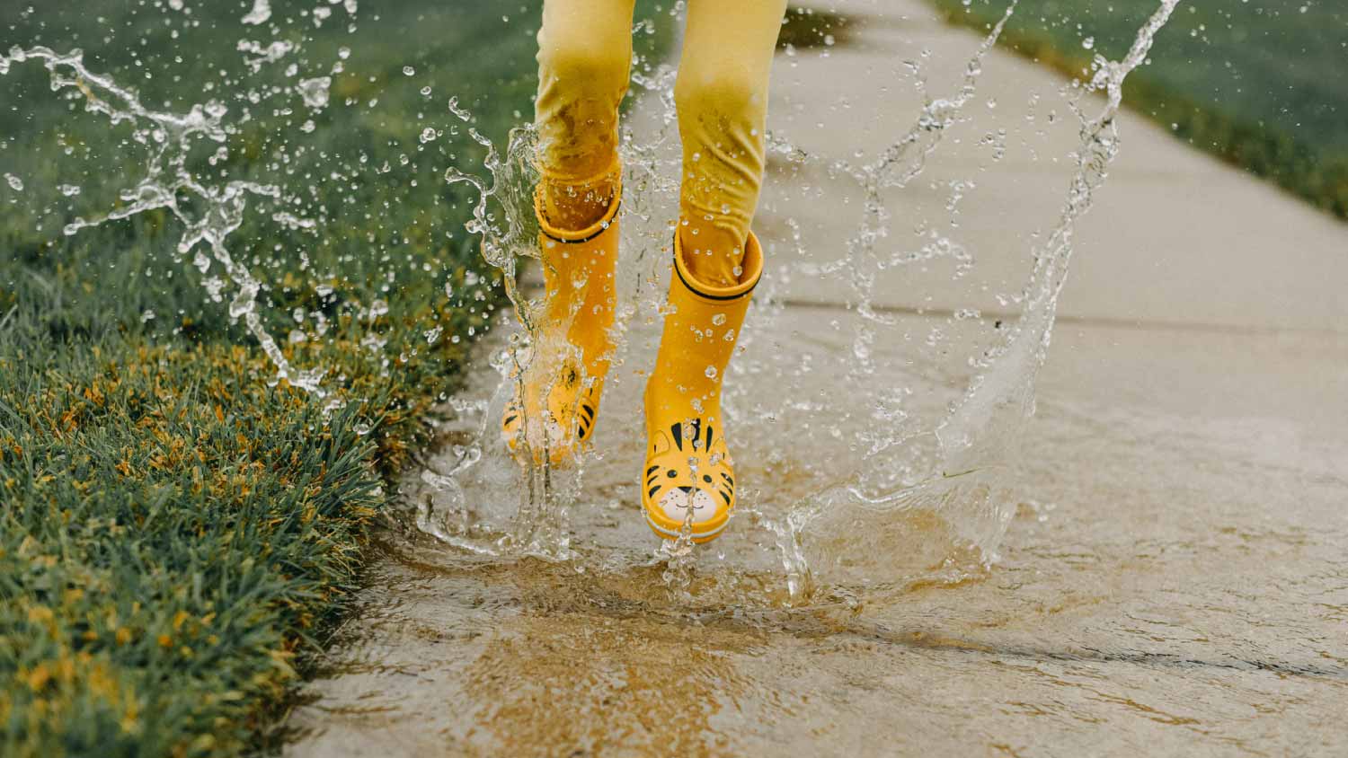 Little girl wearing yellow rain boots