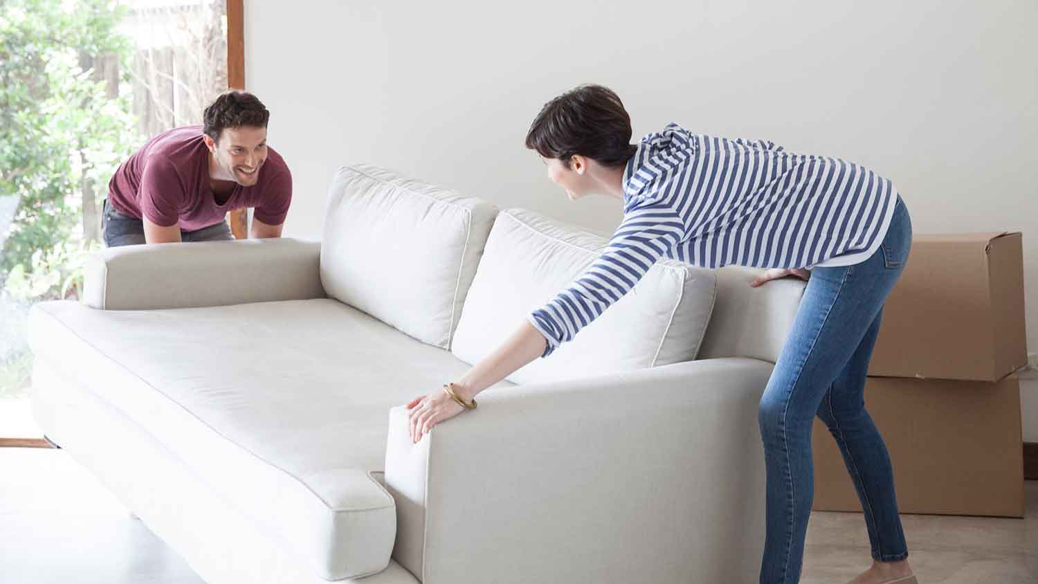 Couple arranging furniture in the living room