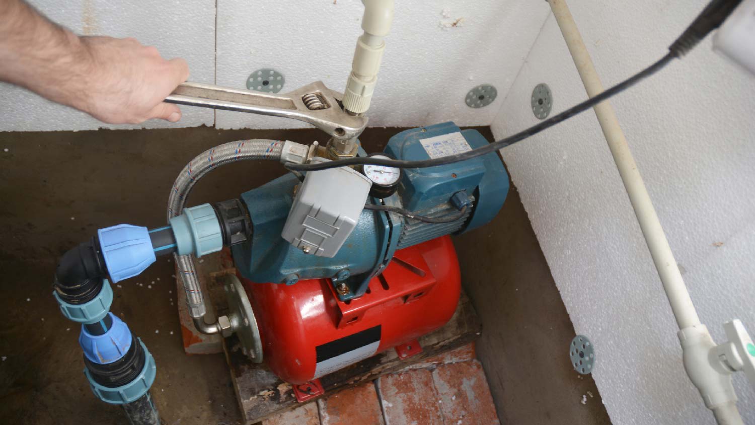 A man repairing a well pump
