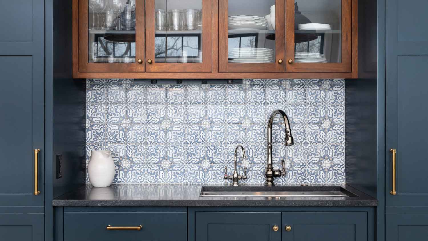 A kitchen with blue inset cabinets