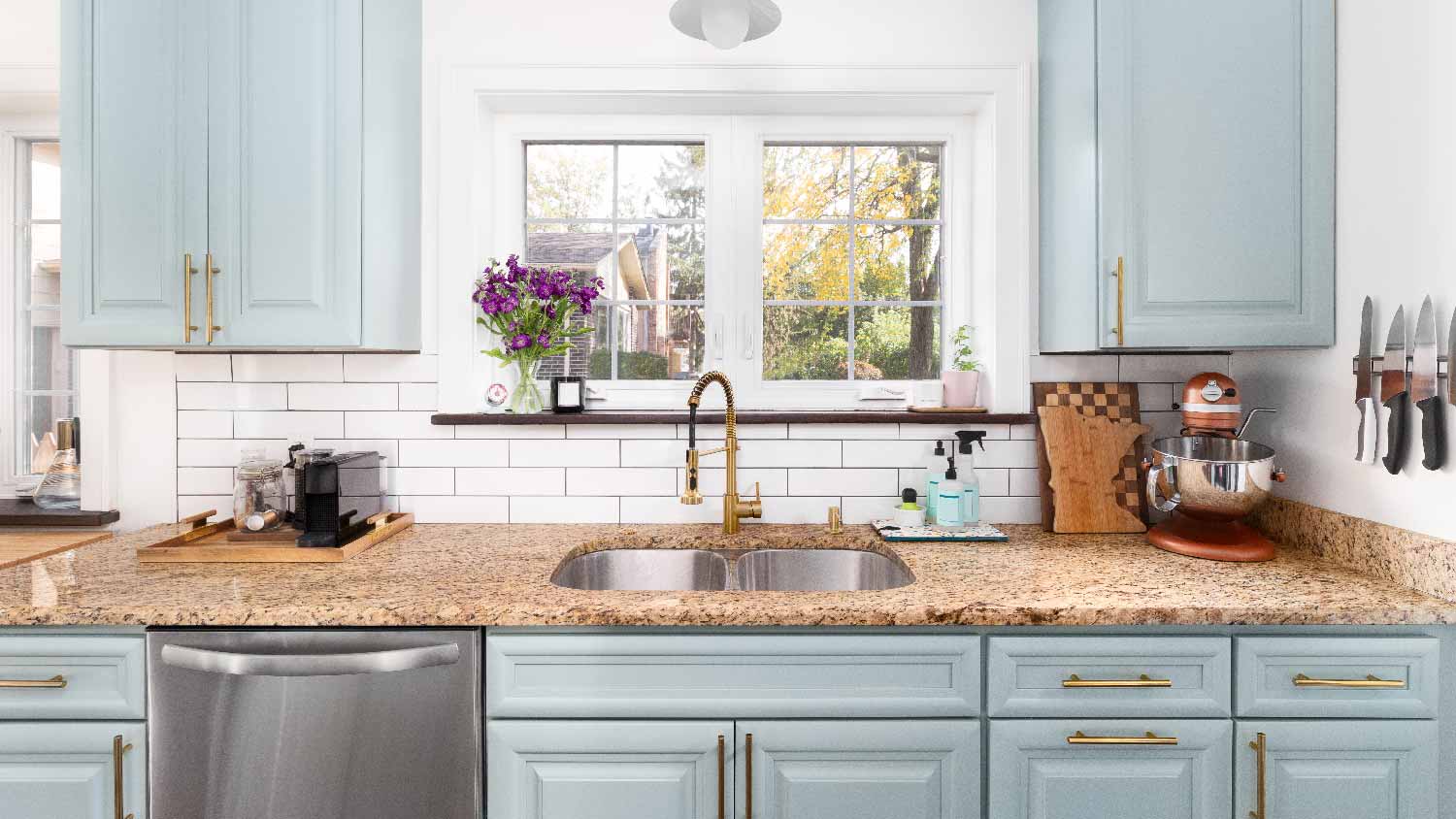 A kitchen with granite countertops and subway tiles for backsplash