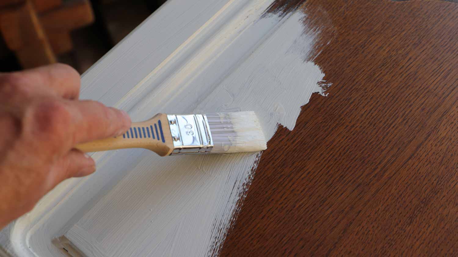 Man painting kitchen cabinet