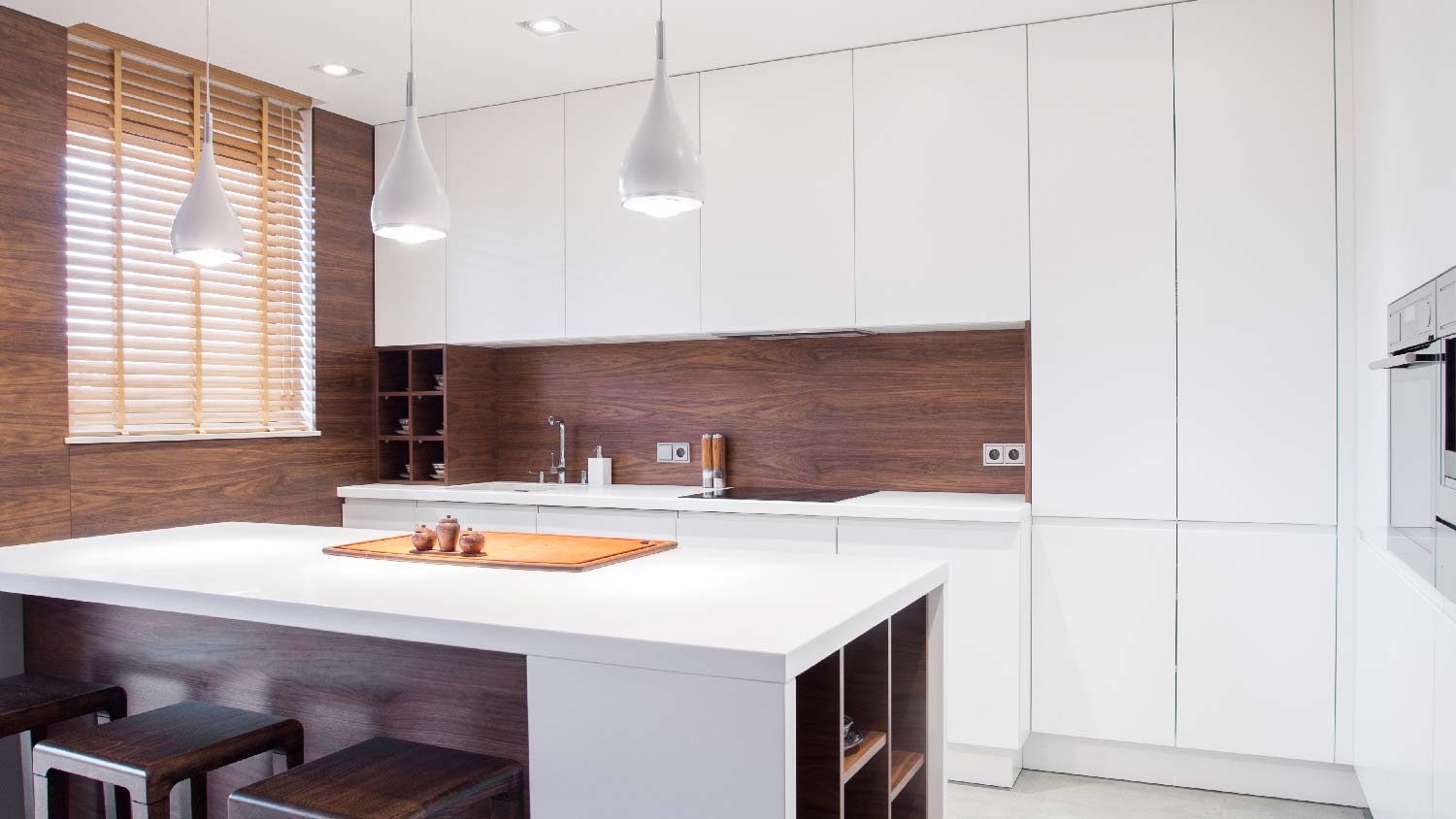 A modern kitchen with a white solid surface countertop