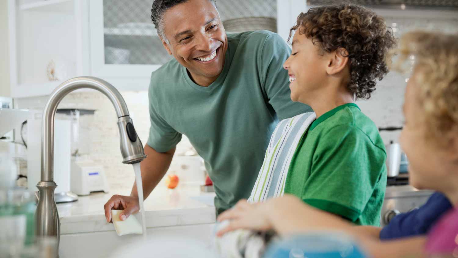 Family washing dishes together