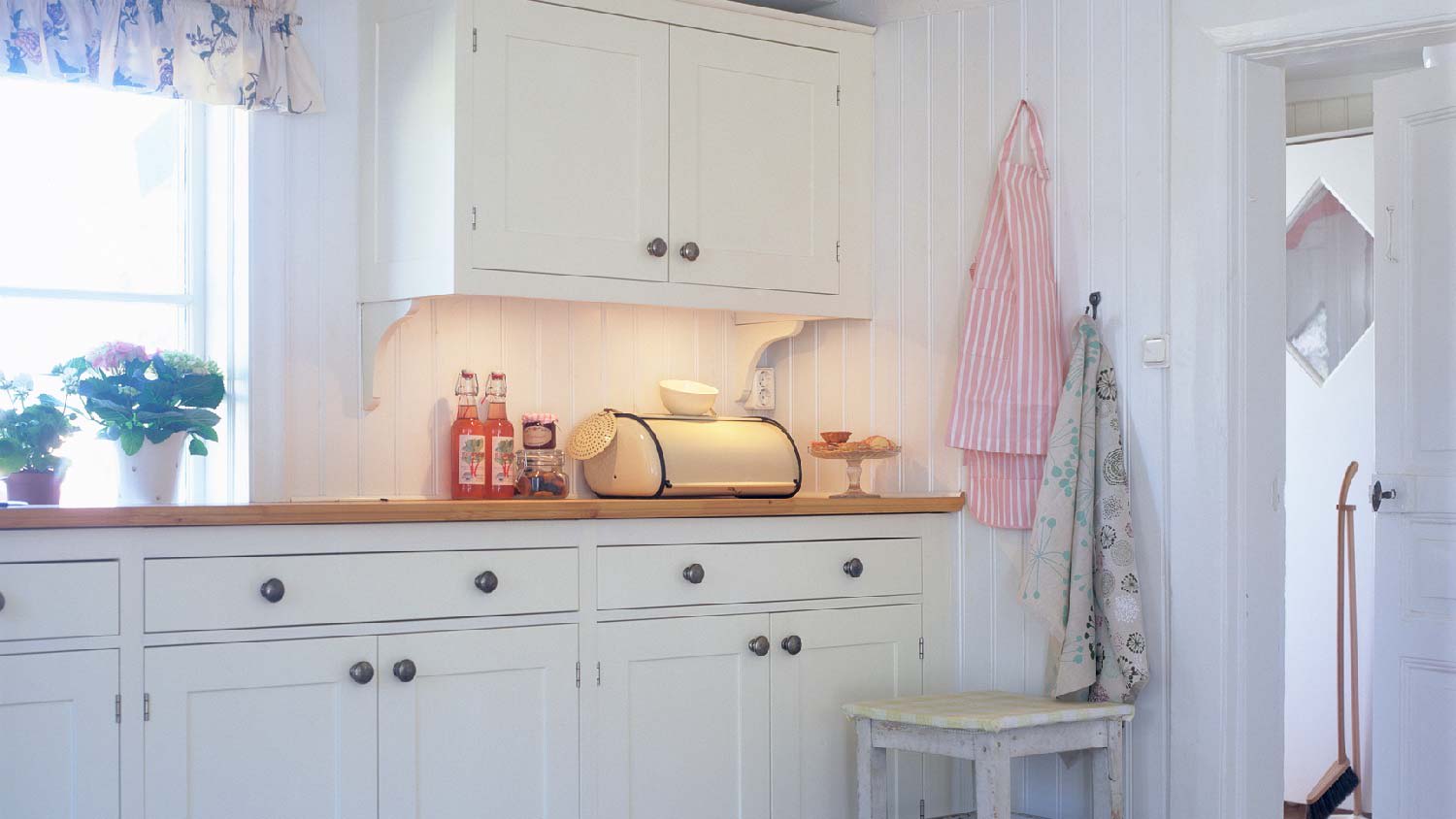 A rustic kitchen with white inset cabinets