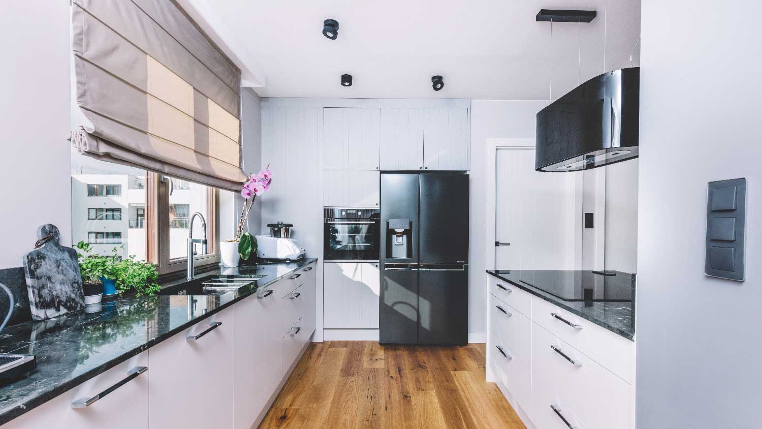 A modern kitchen with a black quartzite countertop