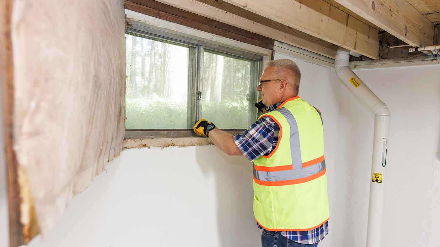 Inspector assessing windows in the basement