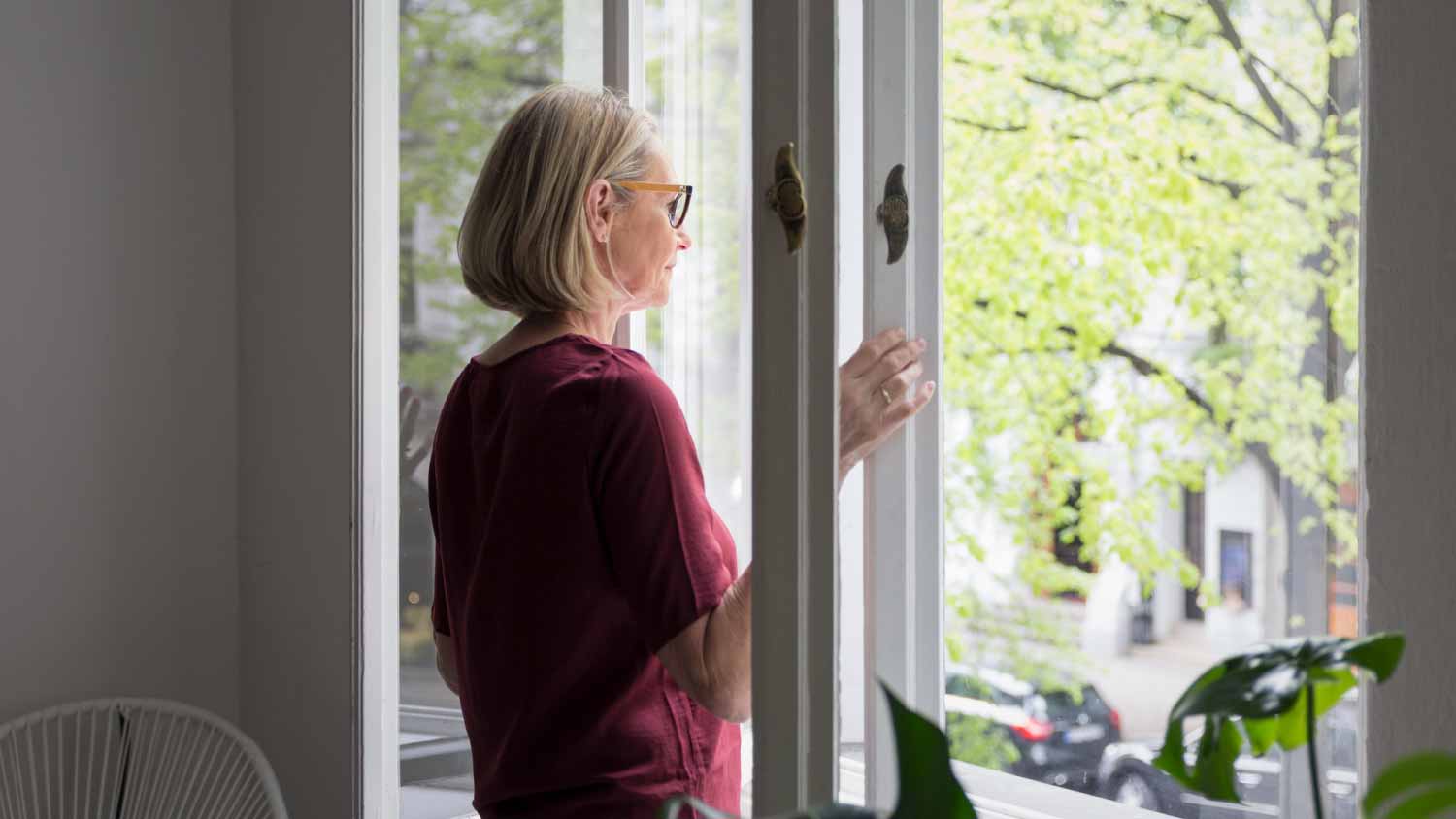 Mature woman opening the window