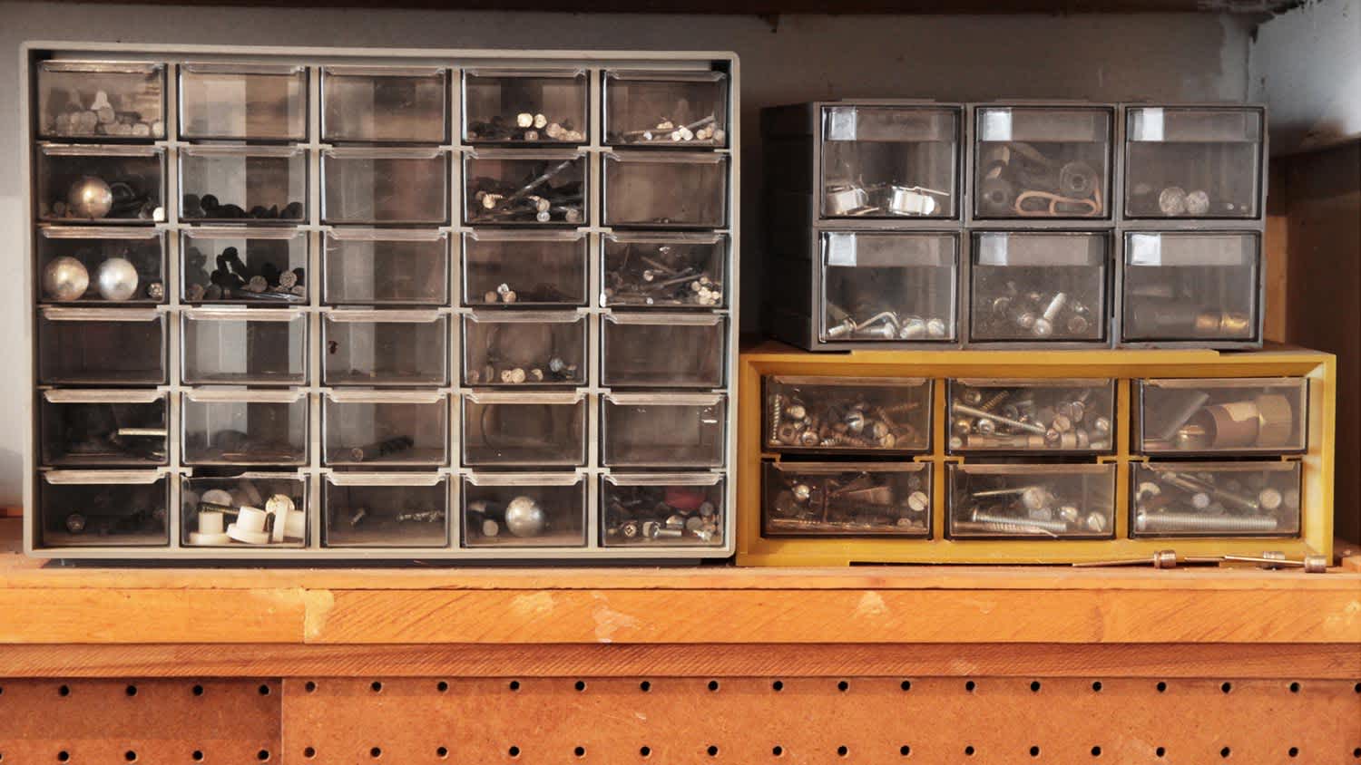 Close-up of screws organized in drawers in a garage workbench