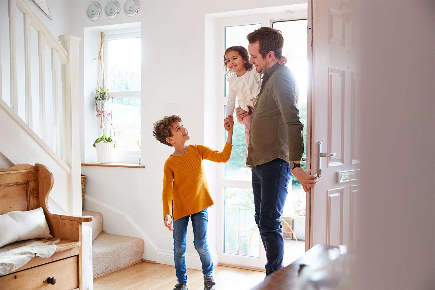 Family entering through the front door of home