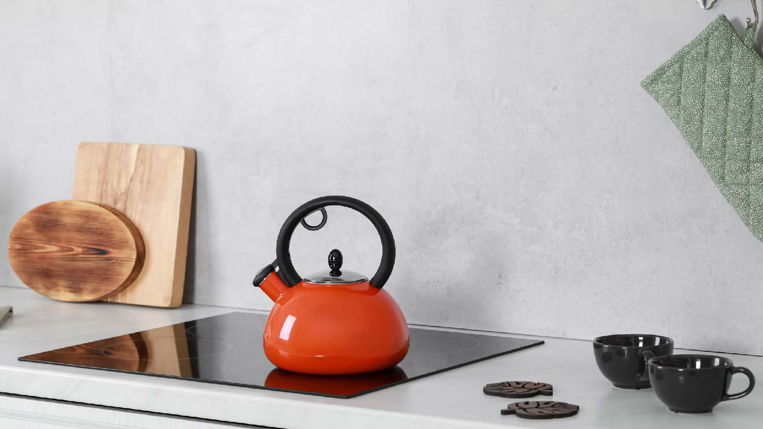 Tea brewing with two cups with their coasters on quartz countertop
