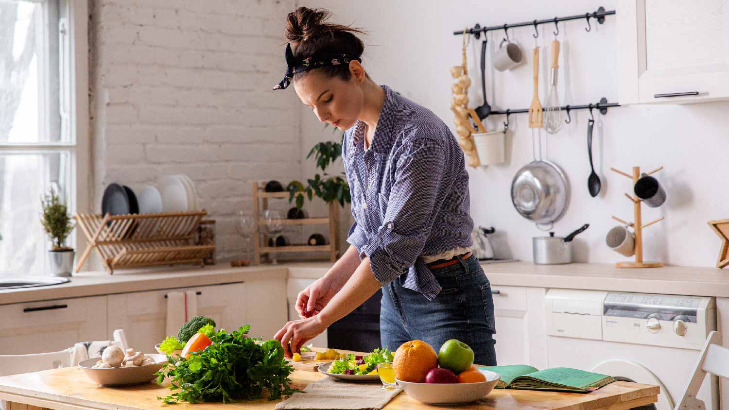 A woman preparing a meal on a wooden countertop