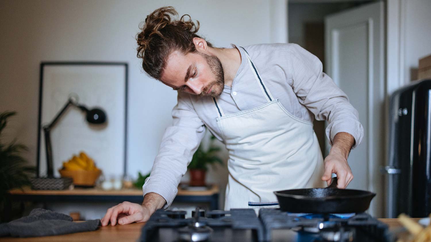 A man cooking on a gas stove