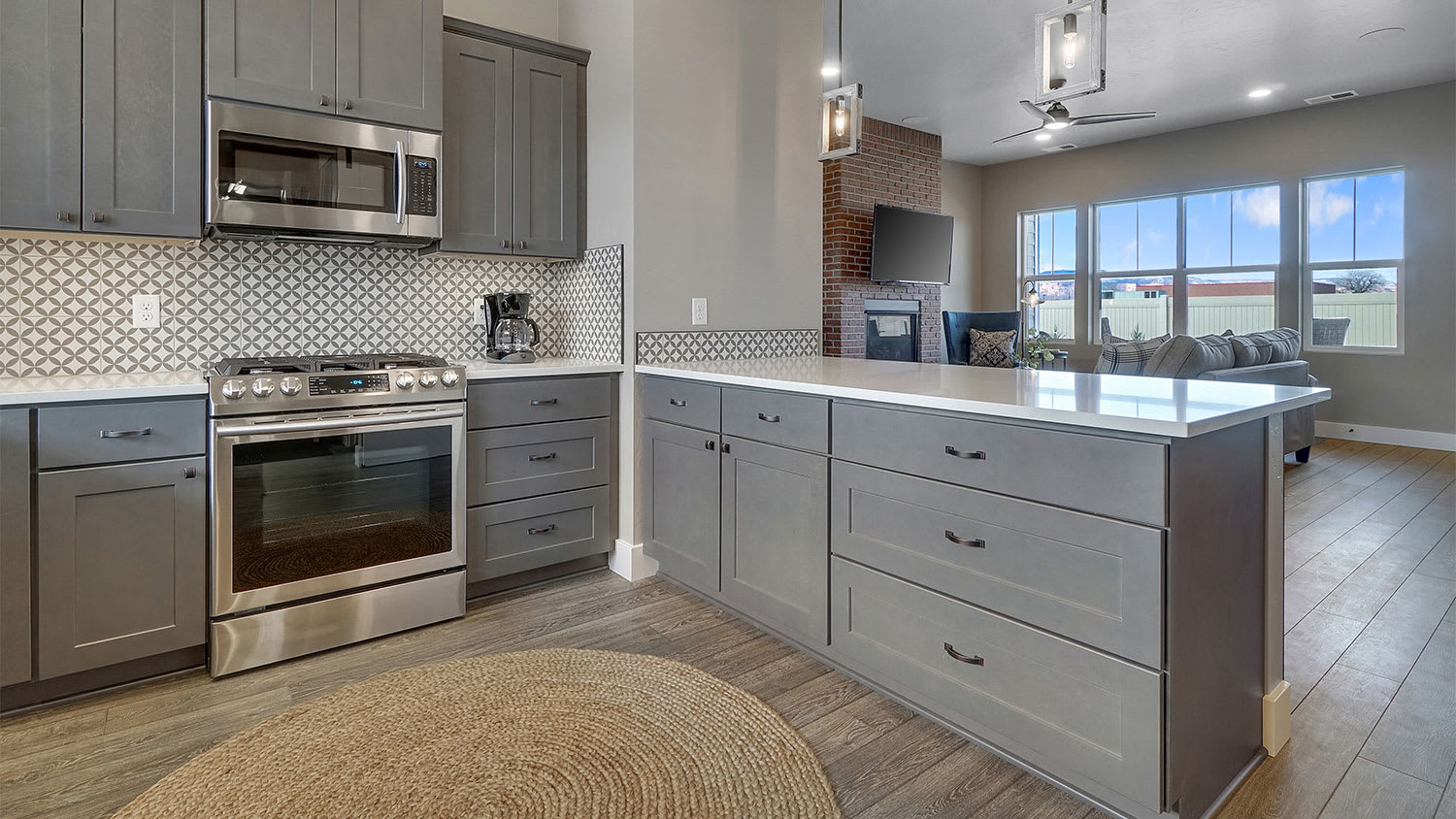 Gray full overlay kitchen cabinets under a white countertop
