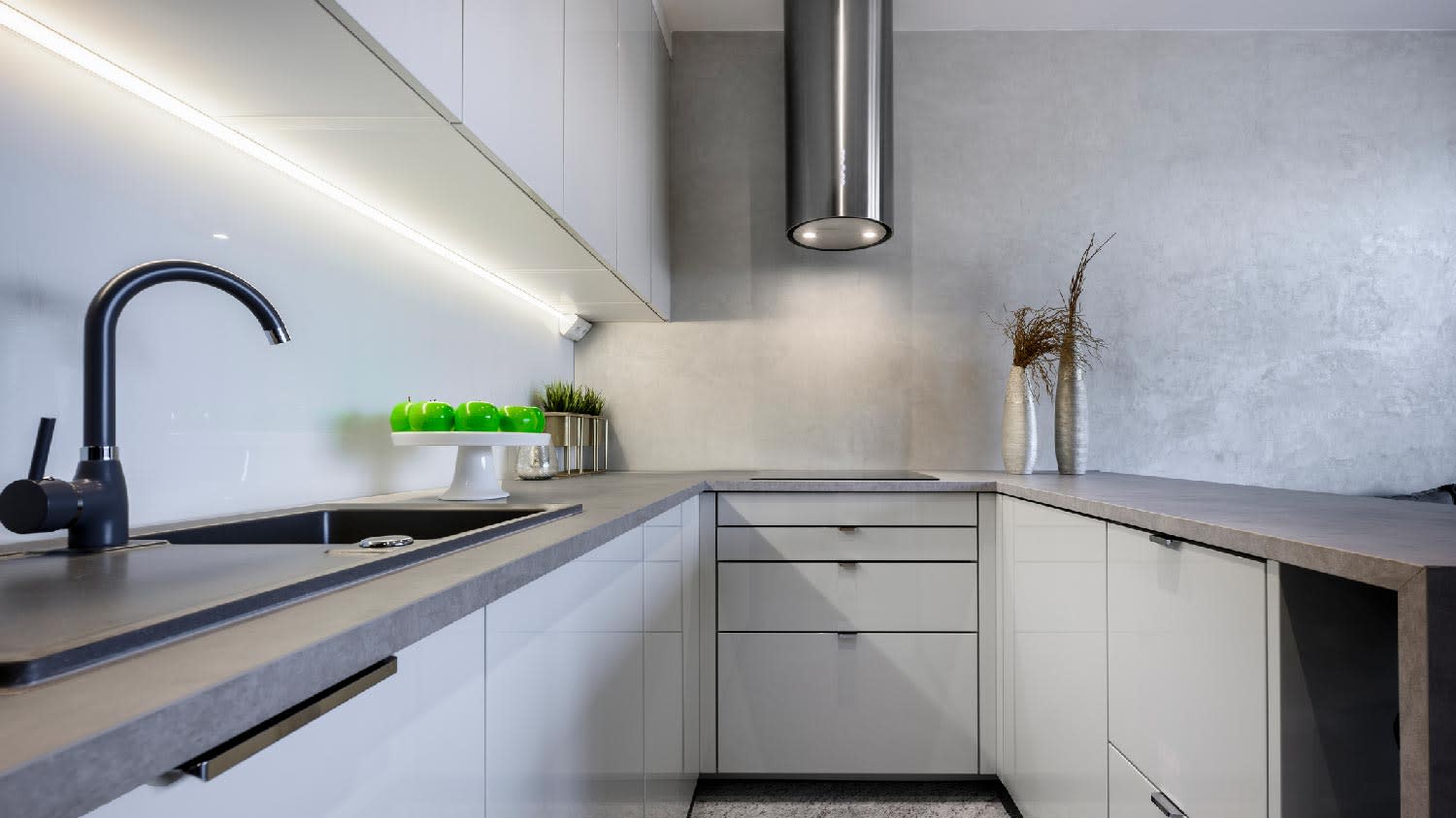 A small kitchen with concrete countertop