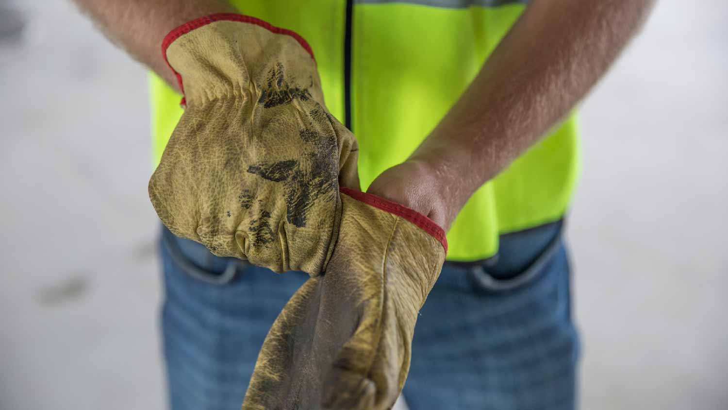 A worker wearing protective gloves