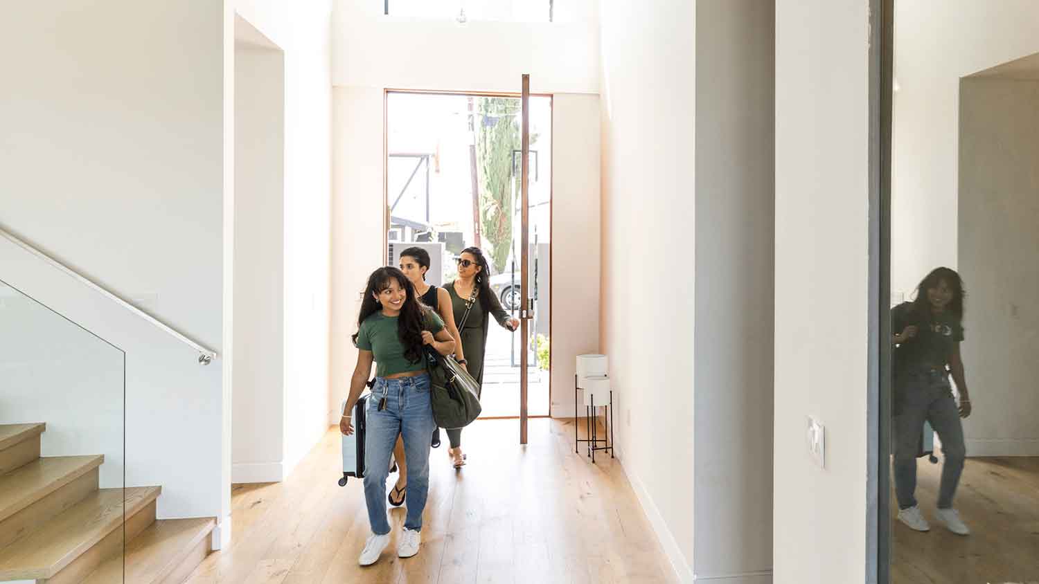 Group of women entering luxury vacation villa