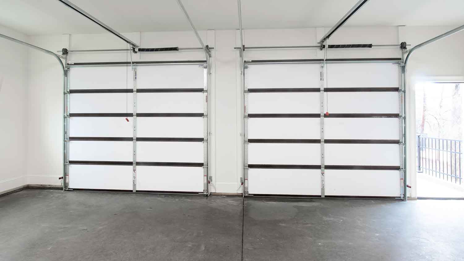 Garage interior with concrete flooring and sectional doors