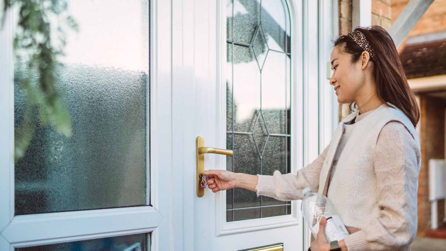 Woman unlocking the front door